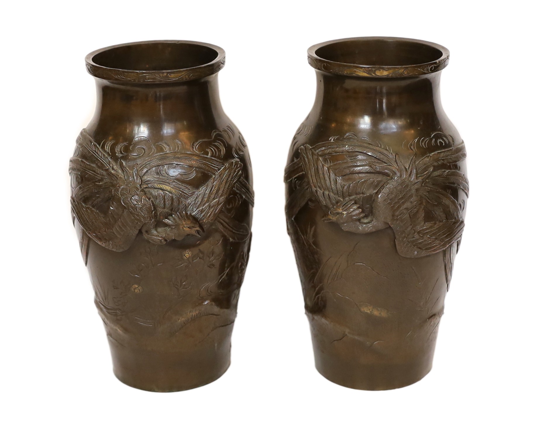 A pair of Japanese Meiji period bronze vases decorated in relief with phoenix, height 27cm